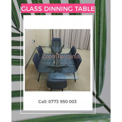 glass dining table with 6 soft cushion grey chairs